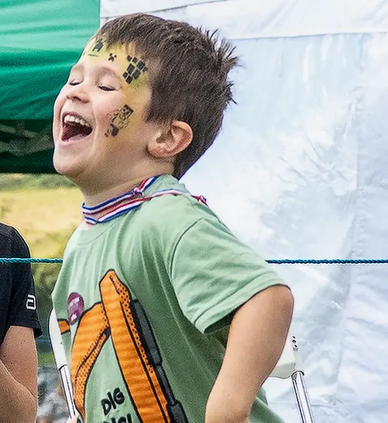 Boy Laughing as he skips